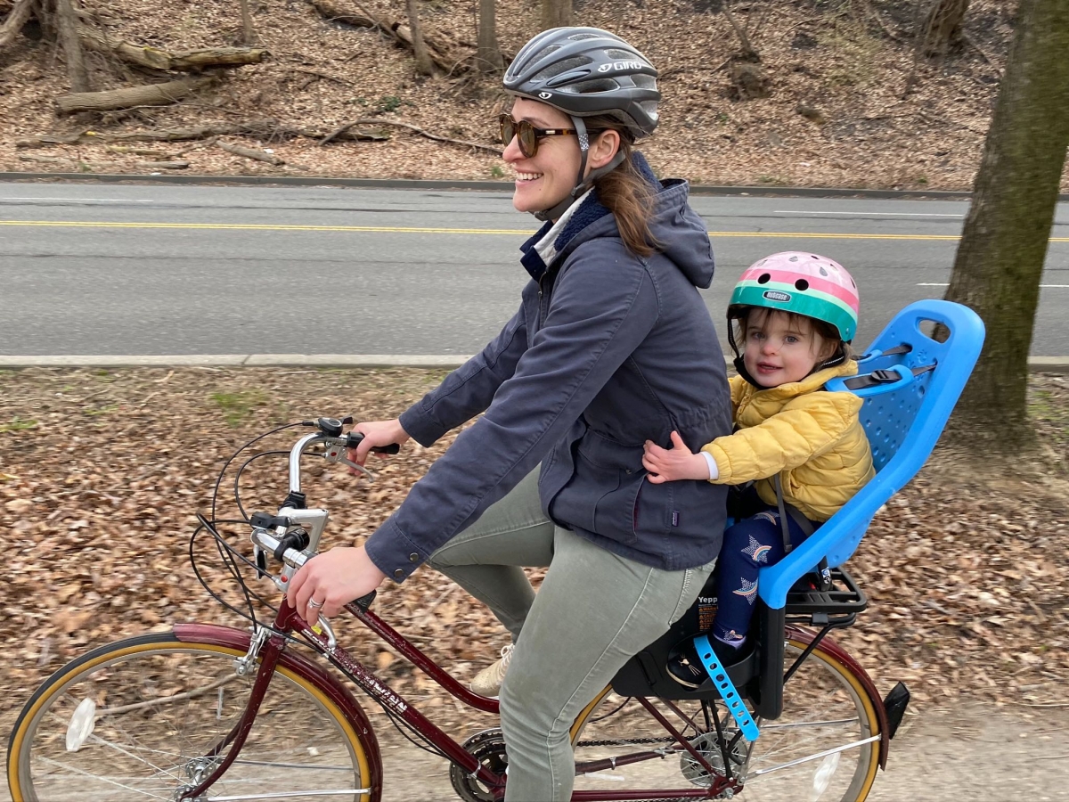 woman biking with a toddler