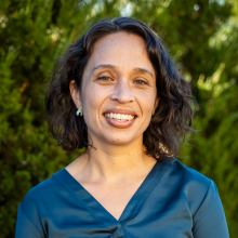 Woman with short hair outside smiling 