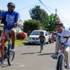 father and two sons riding bikes in street