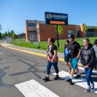 group of students crossing street at crosswalk