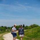 two individuals walking on sidewalk